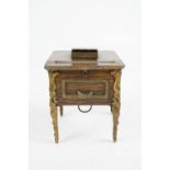 A novelty musical cigarette dispenser in the form of a miniature table with gilt metal legs,