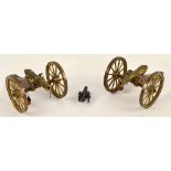 A pair of brass and wooden model cannon, length 20cm and a small modern cannon (3).