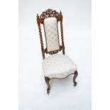 A Victorian walnut side chair with padded back and seat with rope twist uplifts.