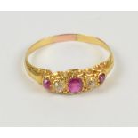 A yellow metal ruby and diamond five stone graduated ring in scroll setting, size R, approx 2.6g.