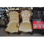Two Victorian walnut scroll back button upholstered salon chairs, one with carving to curved back,