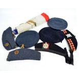 A collection of military berets, caps and bonnets, including The King's Own Scottish Borderers,