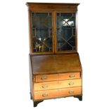 A large Edwardian mahogany bureau bookcase with crossband and string inlay, cornice top,