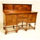 An Edwardian mahogany and inlaid sideboard with raised back,