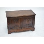 A reproduction oak tv/music cabinet in the form of a coffer,