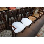A pair of Victorian mahogany pierced splat back salon chairs with padded seats leading to front