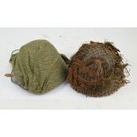 A reproduction helmet with camouflage cover and a further helmet with ghillie cover (2).