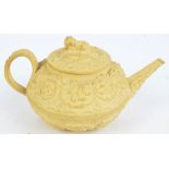 A 19th century Wedgwood cream basalt relief moulded teapot decorated with scrolling flowers and