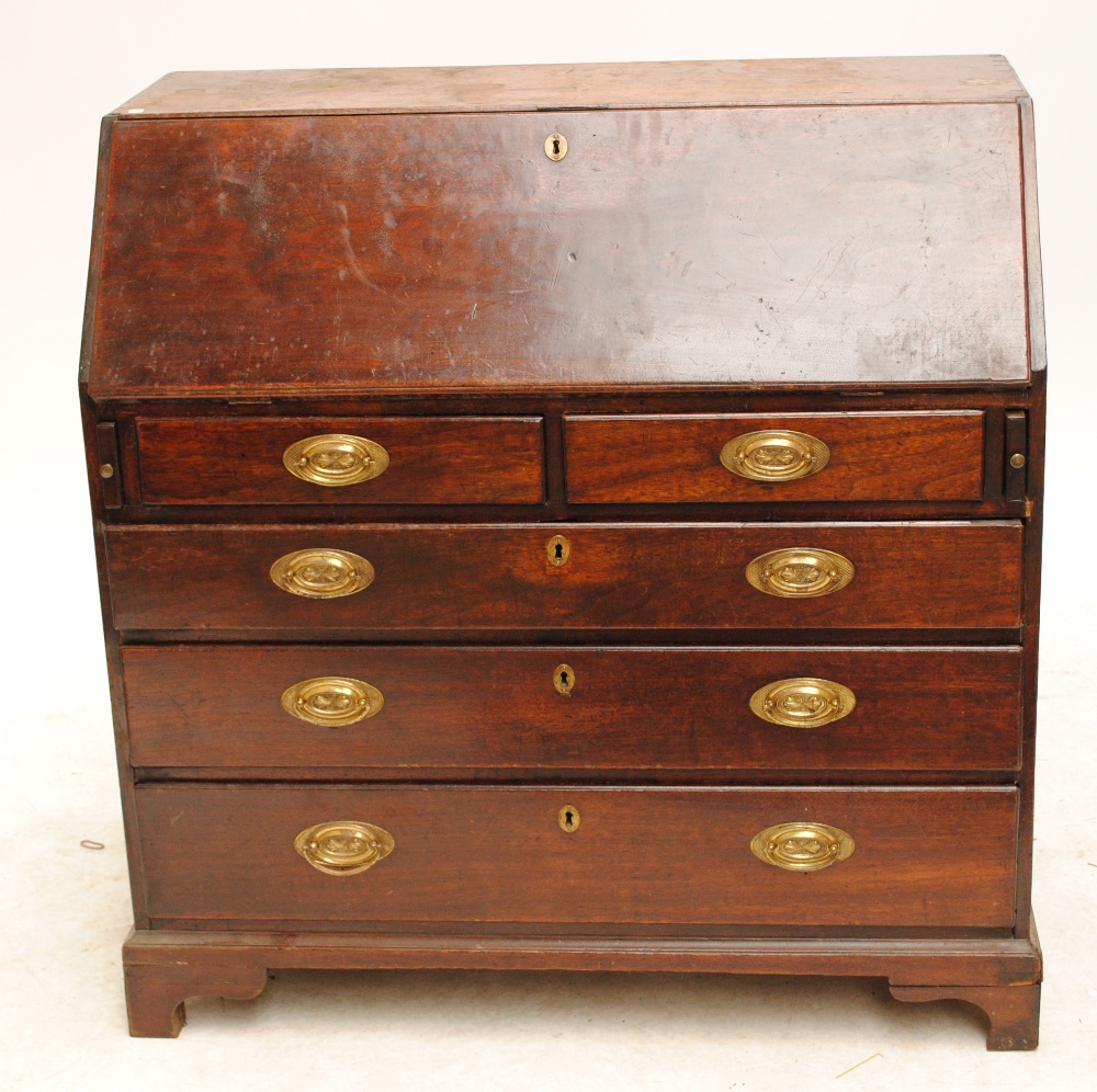 A George III mahogany bureau with fitted interior and two short above two long drawers on bracket