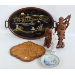 An oval twin handled tray, two root carvings, a shaped Oriental panel,