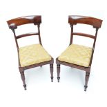 A set of four Victorian mahogany bar back dining chairs with drop-in seats and turned front legs