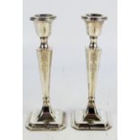 JAMES DEAKIN & SONS; a pair of George V hallmarked silver loaded candlesticks,