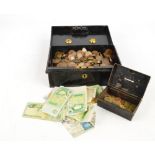 A tin containing a large quantity of coins, predominantly 20th century pennies,
