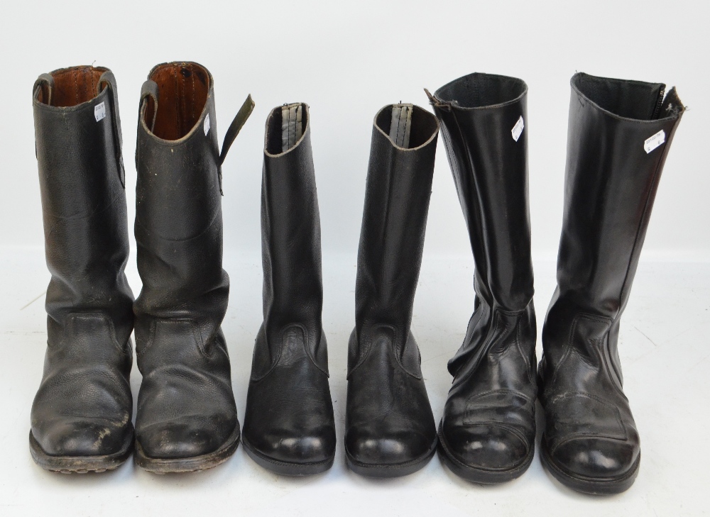 Three pairs of black mid-length boots.