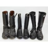 Three pairs of black mid-length boots.