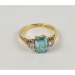 An 18ct yellow gold blue zircon and diamond set three stone ring, size N½, approx 4.2g.