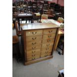 An early 20th century mahogany and stained beech double bank of nine drawers,