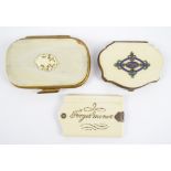 A 19th century ivory coin purse, with white metal enamel inlaid oval and fleur de lys decoration,