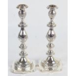 A pair of large George V hallmarked silver Shabbat candlesticks with campana shaped and garland