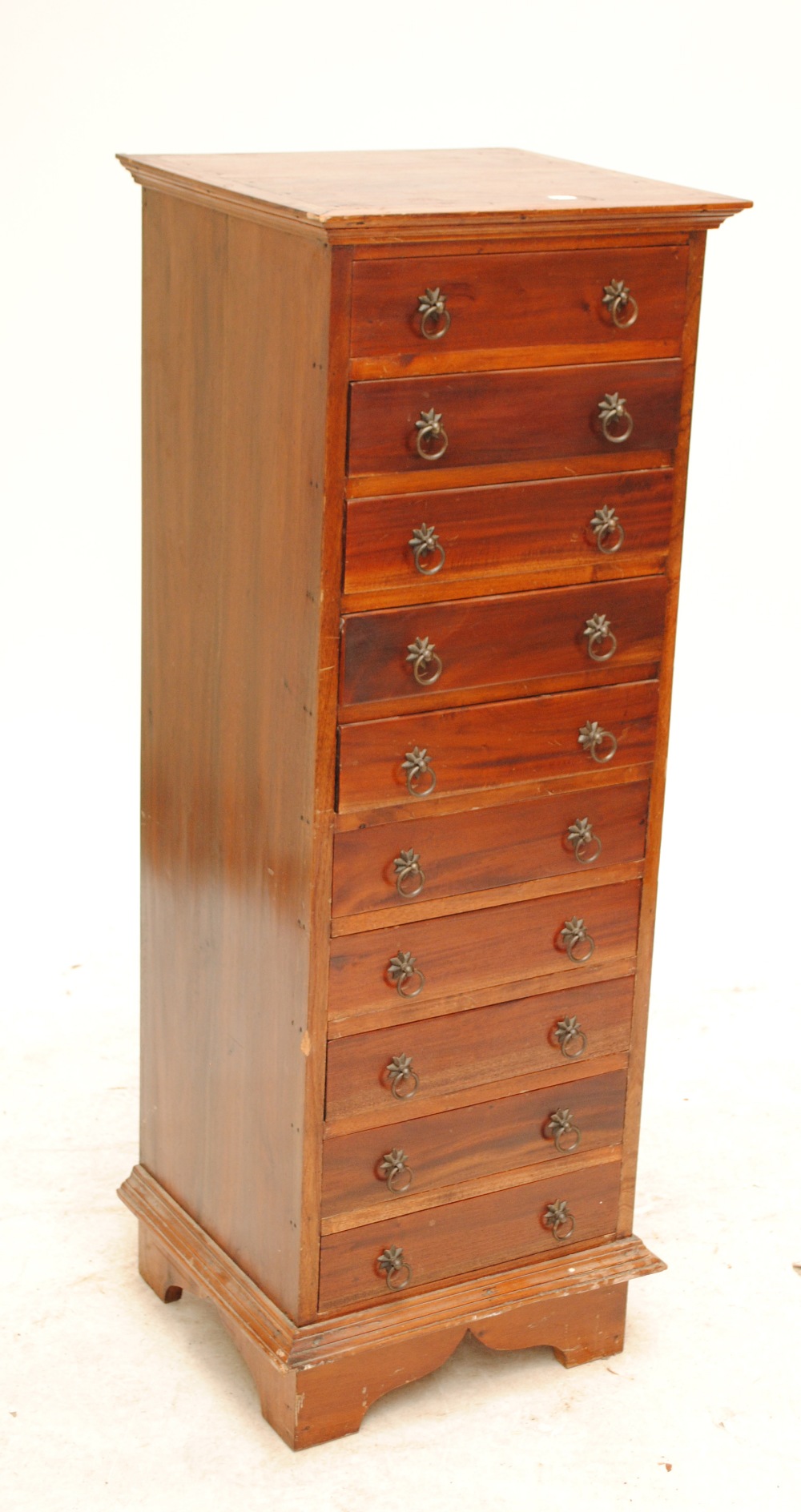 A tall narrow chest of nine drawers on bracket feet, top 46 x 42cm, height 124cm.