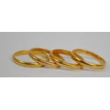 Four 22ct yellow gold wedding bands, size H, two size K and L (4).