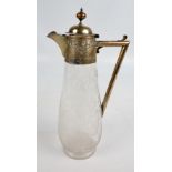 An Edward VII hallmarked silver collared claret jug with repoussé foliate decoration and angled