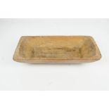 A rustic pine one-piece dough trough with adzed shaping, length 53cm.