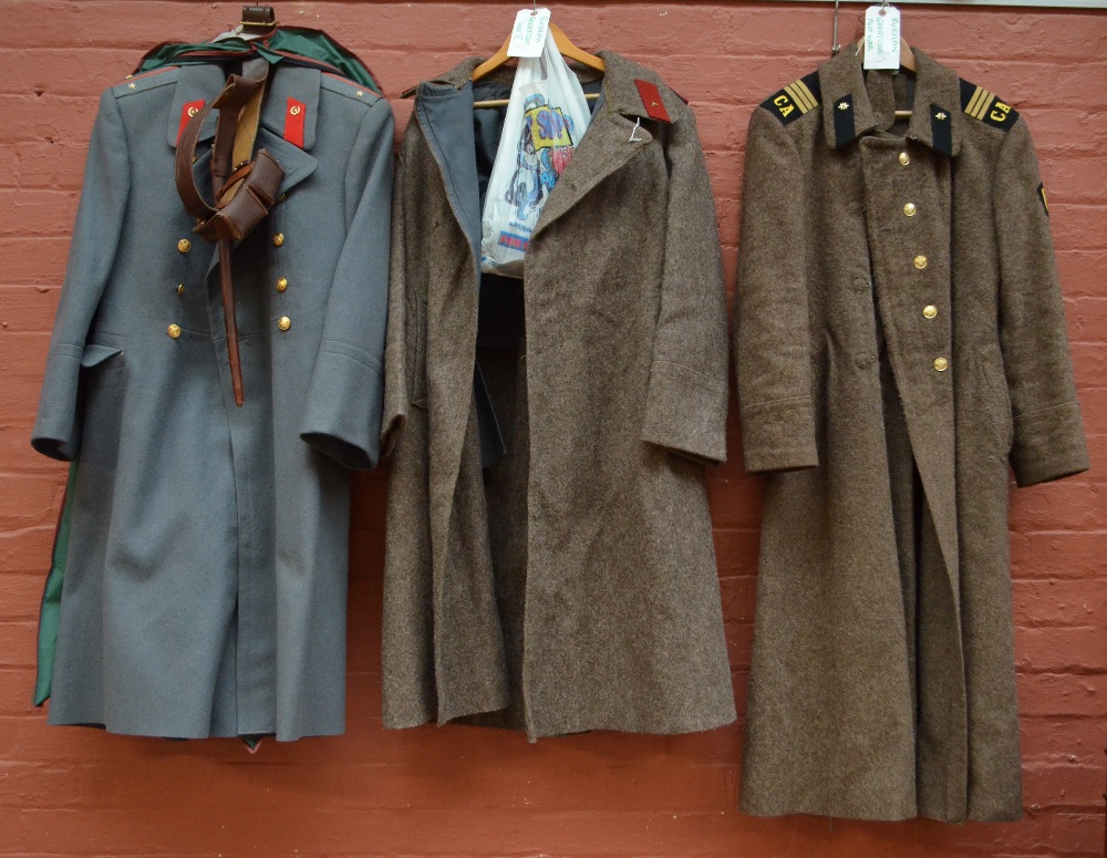 A WWII Russian wool great coat, a further post war great coat with hammer and sickle buttons,