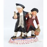 An early 19th century Staffordshire figure group 'Town Crier and Drunk', height 22cm.