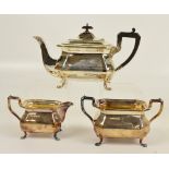 A George V hallmarked silver three piece tea set of panelled rectangular form, Sheffield 1925,