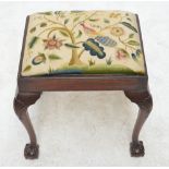 A 19th century dressing or music stool with carved cabriole legs to ball and claw feet,