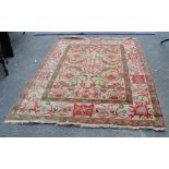 A Turkish design red and green ground floral decorated rug, 180 x 253cm.