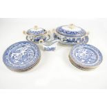 A small quantity of blue and willow pattern dinner ware including an oval twin handled tureen and