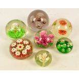 Seven glass paperweights to include Murano floral decorated example and cranberry Bohemia glass