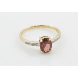 A 9ct yellow gold garnet and diamond ring,