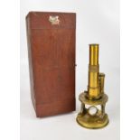 A c.1900 pitch pine case brass monocular microscope, unnamed (af), height approx 23cm.