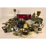 A group of various electroplated items including two three piece tea sets, a claret jug,