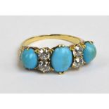 A yellow metal ring set with three turquoise cabochons and central oval cabochon flanked by two