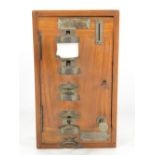 An unusual early 20th century walnut cased hotel night light dispenser,