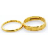 A 22ct yellow gold wedding band with engraved decoration, size M, and a further plain example,