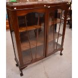 A 20th century mahogany astragal glazed twin-door display cabinet with two shelves,