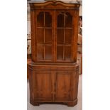 A reproduction-style walnut corner cupboard,