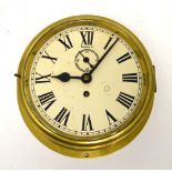 A brass-cased ship's clock, dial set with Roman numerals, diameter 25cm.