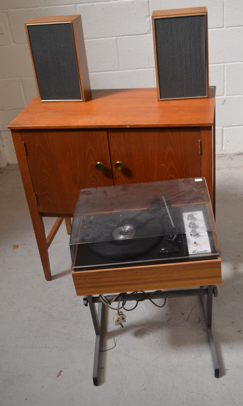 A retro teak twin-door record cabinet, width 76cm, containing a quantity of vinyl,