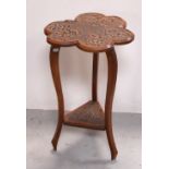 An oak shamrock-shaped occasional table with carved shamrock decoration,