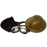 A c1930s style leather driving helmet and goggles and a WWII military helmet (3).