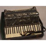 A cased black Pietro piano accordion.