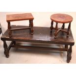 An Oriental-style tooled leather-topped coffee table on baluster supports and cross stretcher,