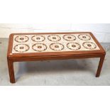 A c1960/70s rectangular teak coffee table inset with floral ceramic tiles,