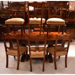 An oak draw-leaf dining table raised on heavily carved bulbous supports,